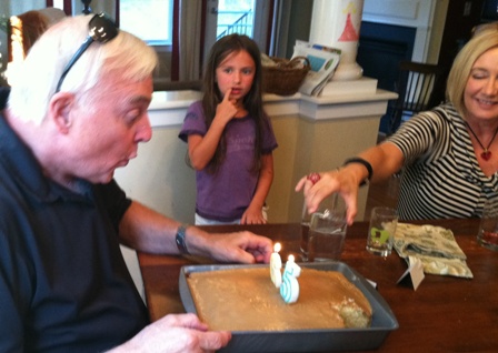 Dad blowing out the candles on his birthday cake